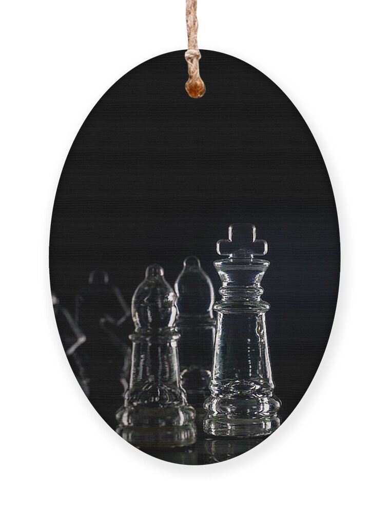 Rule Ornament featuring the photograph Miniature figure people as businessman standing face to face with King chess piece on chessboard. macro by Pablo Avanzini