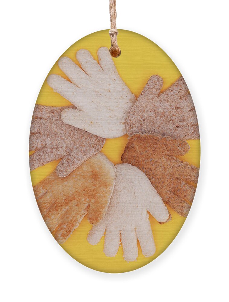 Hands Ornament featuring the photograph Multicultural hands circle concept made from bread by Simon Bratt