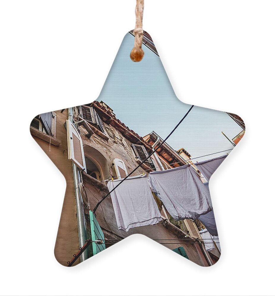 Croatia Ornament featuring the photograph Narrow Alley With Old Houses And Freshly Washed Laundry In The City Of Rovinj In Croatia by Andreas Berthold