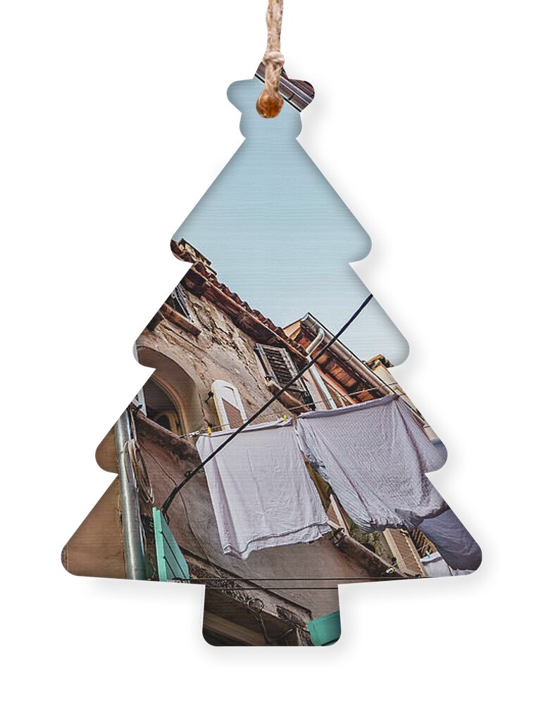 Croatia Ornament featuring the photograph Narrow Alley With Old Houses And Freshly Washed Laundry In The City Of Rovinj In Croatia by Andreas Berthold