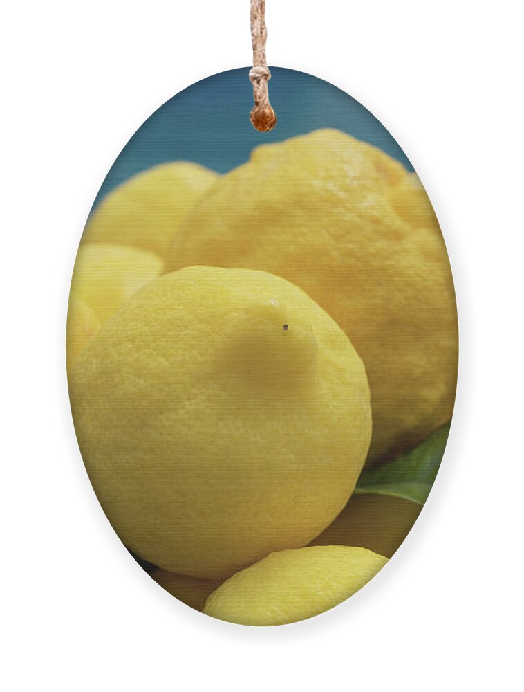 Lemon Tree Ornament featuring the photograph Natural lemons and lemon leaves by the pool by Adriana Mueller