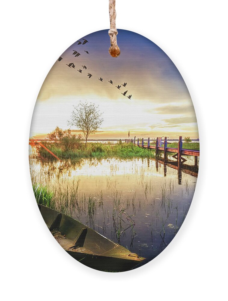 Birds Ornament featuring the photograph Rowboat in the Marsh at Sunset by Debra and Dave Vanderlaan