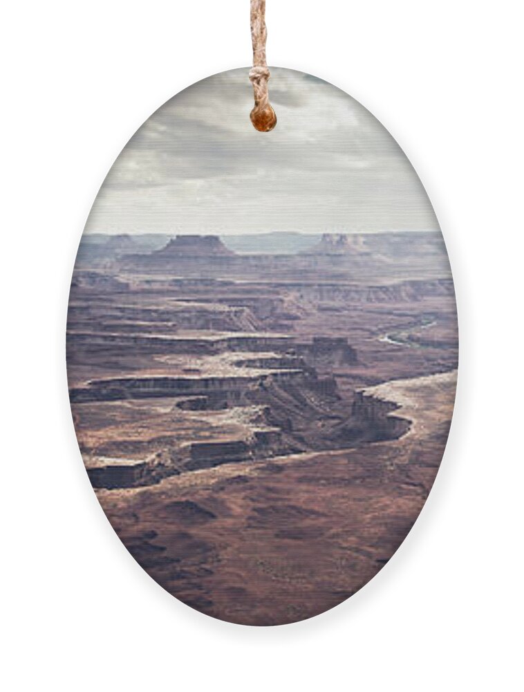 America Ornament featuring the photograph Scenic view in canyonland with storm in the distance by Jean-Luc Farges