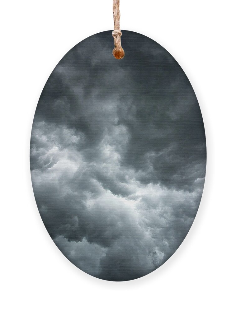 Clouds Ornament featuring the photograph Stormy clouds in the sky. by Bernhard Schaffer