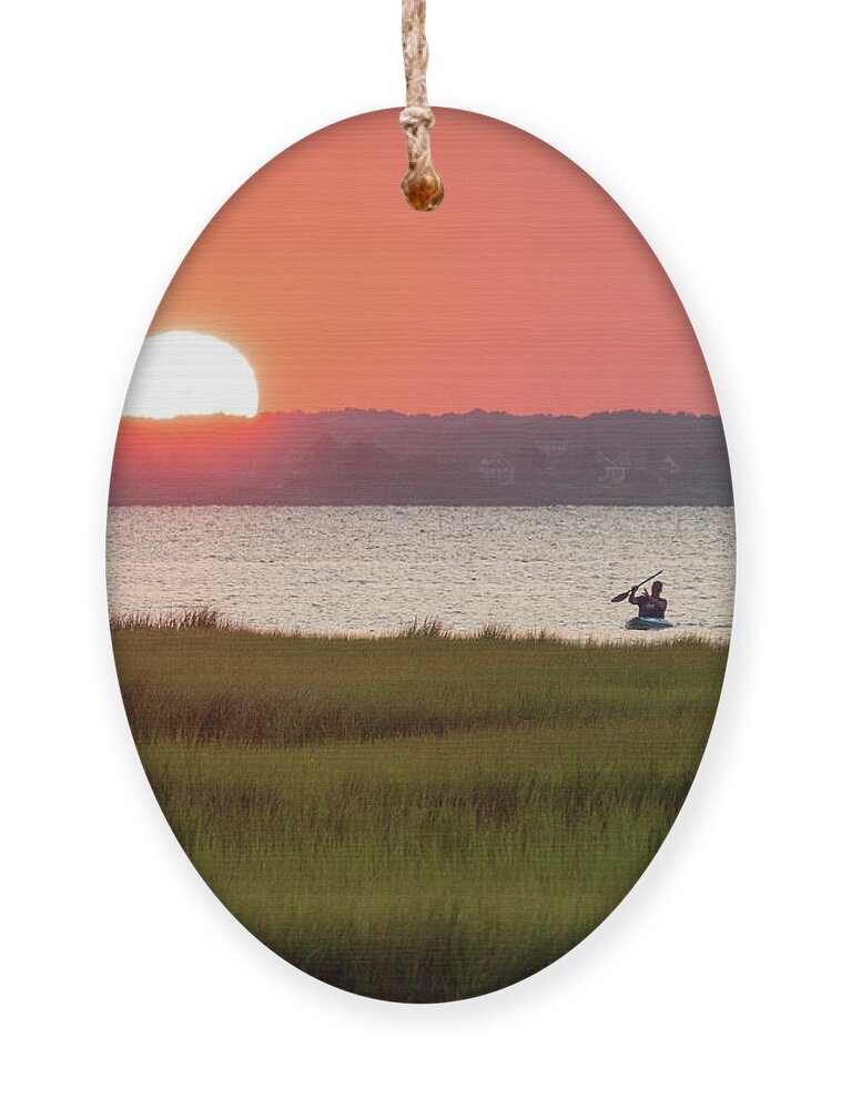 Assawoman Bay Ornament featuring the photograph Sunset over a bay by Izet Kapetanovic