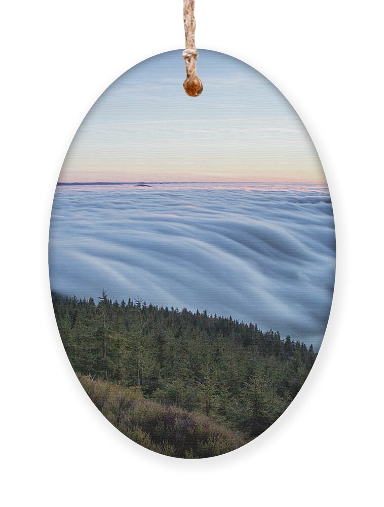 Courage Ornament featuring the photograph Sunset with floating blue waves of clouds by Vaclav Sonnek