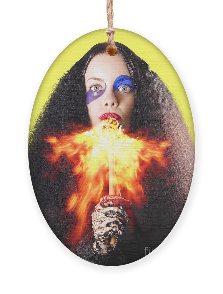 Fire Ornament featuring the photograph Woman breathing fire from mouth by Jorgo Photography