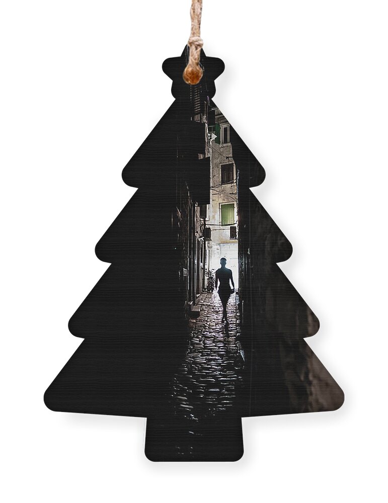  Ornament featuring the photograph Young Woman Walks Alone Through Spooky Narrow Abandoned Alley In The Night by Andreas Berthold