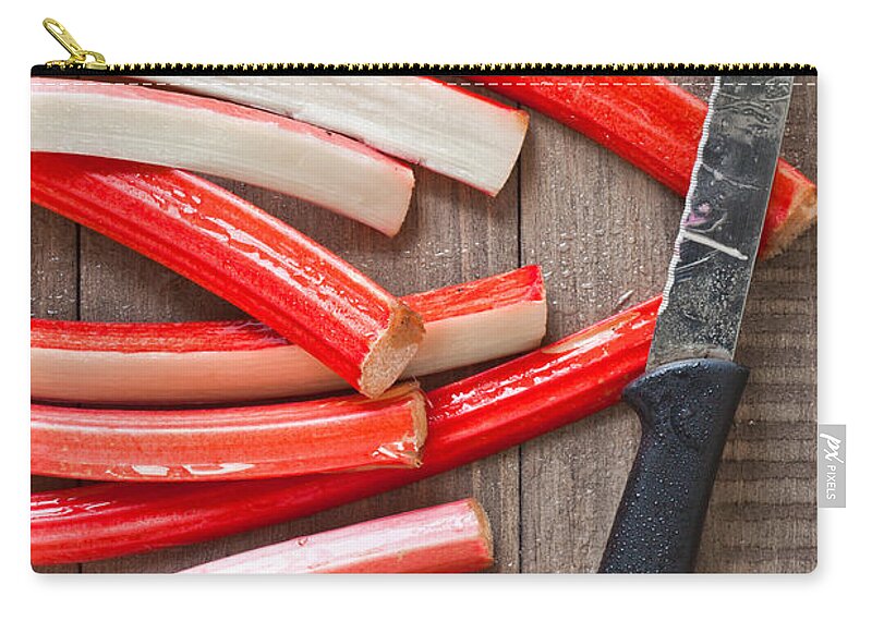 Background Zip Pouch featuring the photograph Cutting rhubarb #2 by Tom Gowanlock