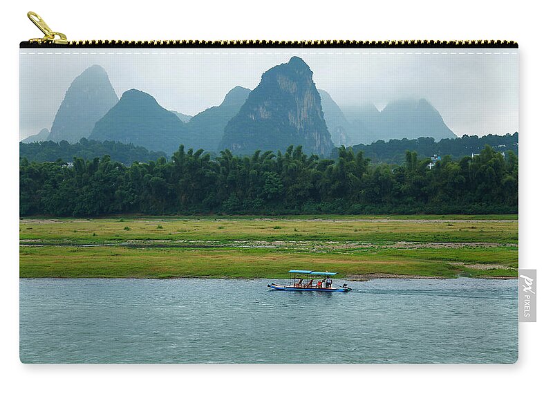 Tranquility Zip Pouch featuring the photograph A Bamboo Raft Along The Li River In by Nisa And Ulli Maier Photography