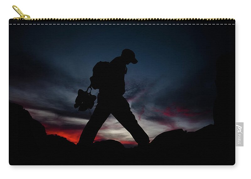 Adventure Zip Pouch featuring the photograph A Man Hikes In Joshua Tree, California by Kyle Sparks