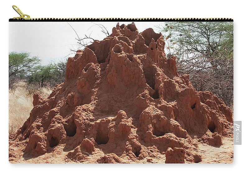 Kenya Zip Pouch featuring the photograph A Mound Of Red Dirt With Numerous Holes by Diane Levit / Design Pics