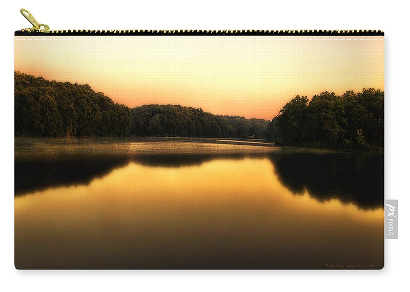 Sunrise Zip Pouch featuring the photograph A Soft Sunrise On A Lake by Thomas Woolworth