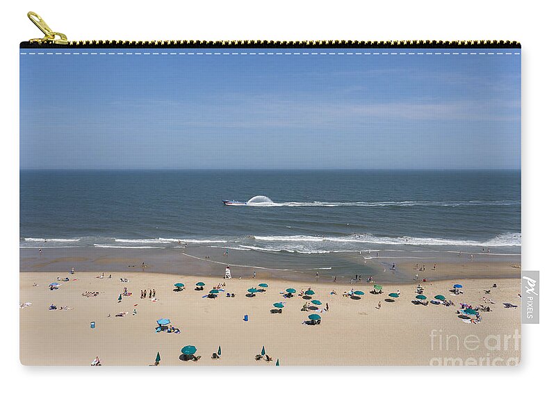 Atlantic Zip Pouch featuring the photograph A touring speedboat passes by shore in Ocean City Maryland by William Kuta