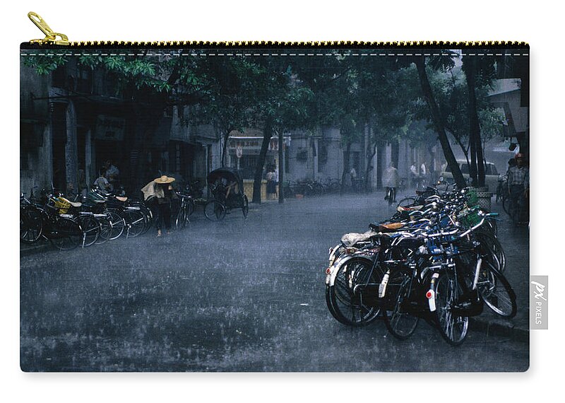 Season Zip Pouch featuring the photograph A Tropical Storm Rains Down On Bicycles by Dallas Stribley