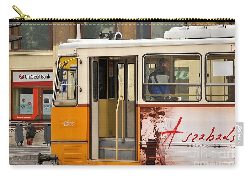 Tram Zip Pouch featuring the photograph A yellow tram on the streets of Budapest Hungary by Imran Ahmed