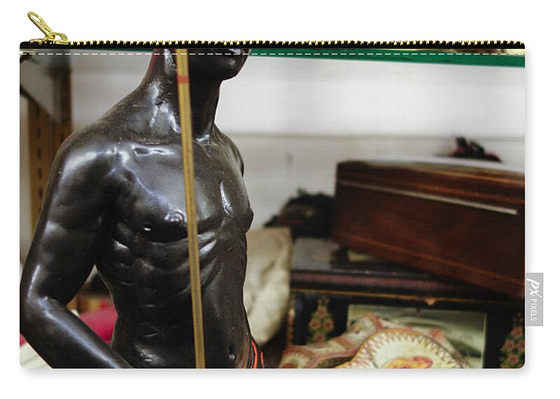 African Zip Pouch featuring the photograph African man statue with spear by Amy Cicconi