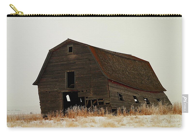 Barns Zip Pouch featuring the photograph An Old Leaning Barn In North Dakota by Jeff Swan
