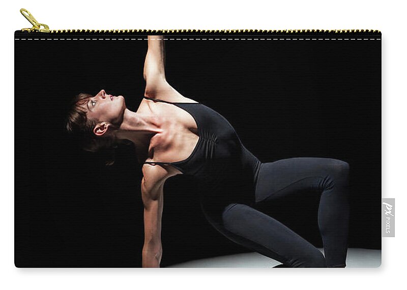 Ballet Dancer Zip Pouch featuring the photograph Ballerina In Spotlight With Arm Raised by Nisian Hughes