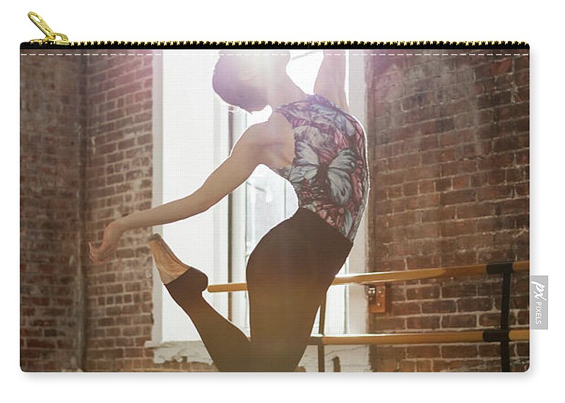 Ballet Dancer Zip Pouch featuring the photograph Ballerina Performing Balance On Pointe by Nisian Hughes