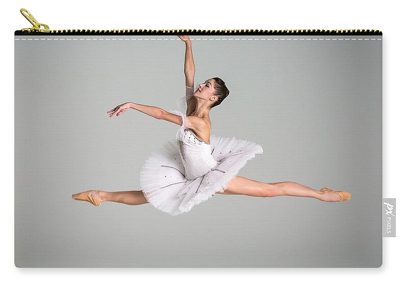 Ballet Dancer Zip Pouch featuring the photograph Ballerina Performing Grand Jeté by Nisian Hughes