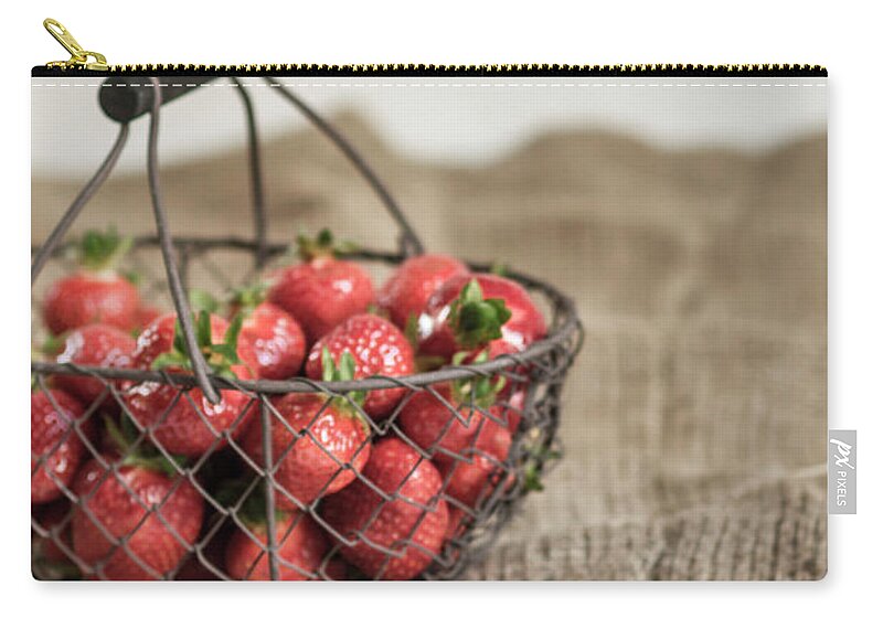 Handle Zip Pouch featuring the photograph Basket Of Strawberries On Rug by Westend61