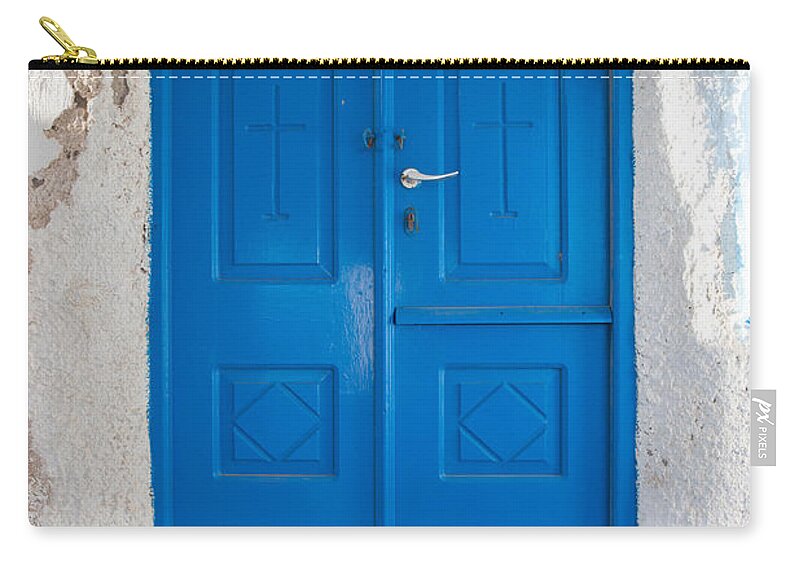 Blue Zip Pouch featuring the photograph Blue door of a church in Santorini by Matteo Colombo