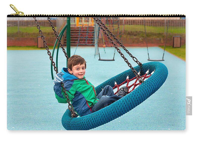 Action Zip Pouch featuring the photograph Boy on swing by Tom Gowanlock