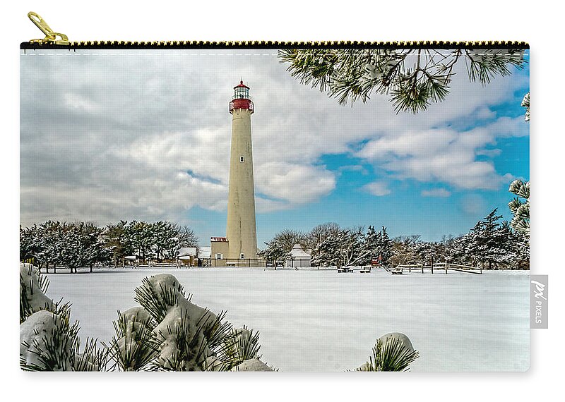 Beacon Zip Pouch featuring the photograph Cape May Light thru Snowy Trees by Nick Zelinsky Jr