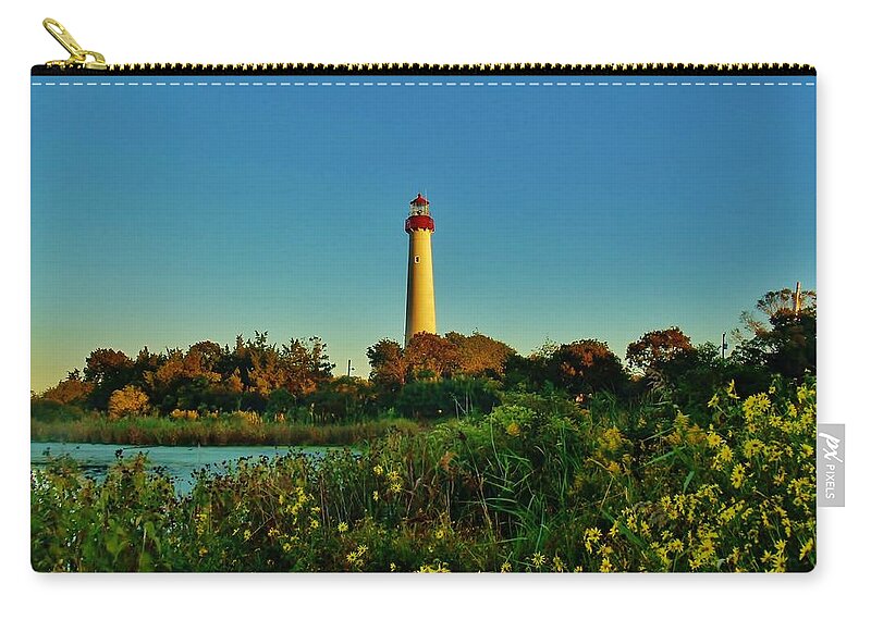 Ocean Zip Pouch featuring the photograph Cape May Lighthouse Above the Flowers by Ed Sweeney