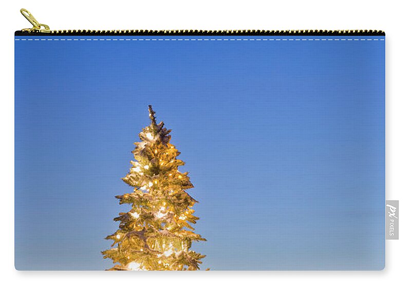 Dawn Zip Pouch featuring the photograph Christmas Tree Decorated And Lit With by Kevin Smith / Design Pics
