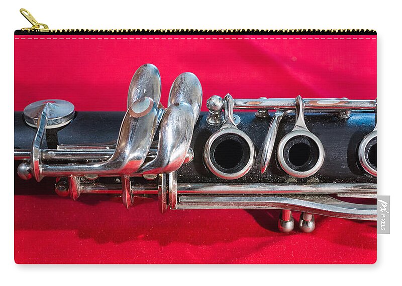Clarinet Zip Pouch featuring the photograph Clarinet on Red by Photographic Arts And Design Studio