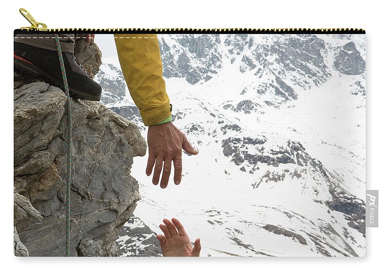 Young Men Carry-all Pouch featuring the photograph Climber Offers Teammate A Helping Hand by Ascent Xmedia