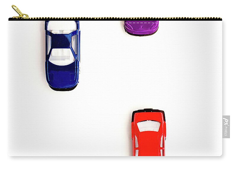 White Background Zip Pouch featuring the photograph Colorful Toy Cars Racing To The Finish by Melissa Ross