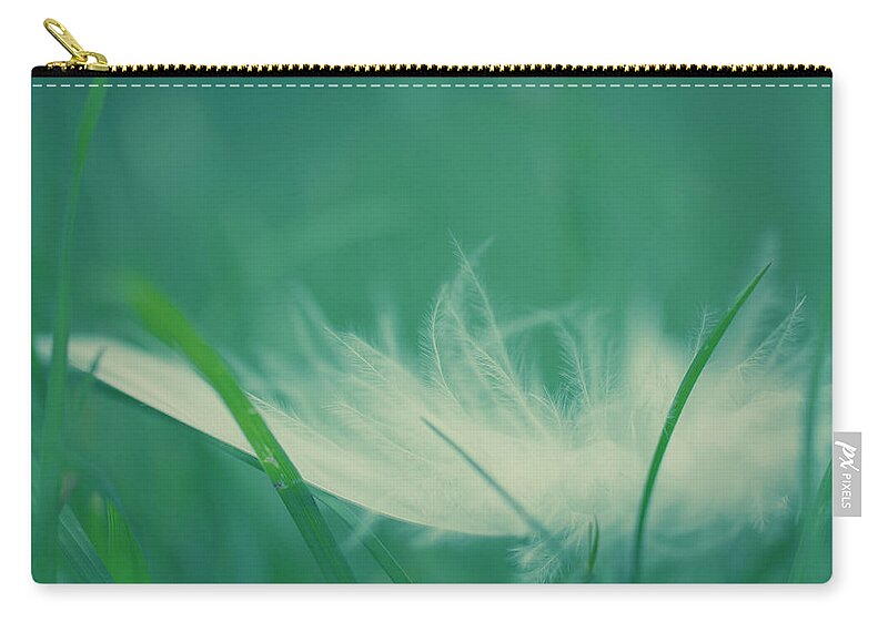 Tranquility Zip Pouch featuring the photograph Feather by Photography By Lana Galina