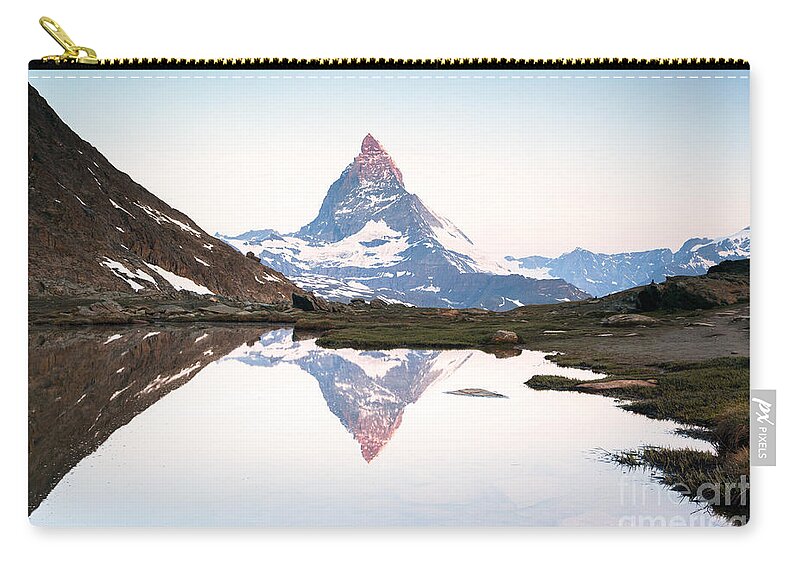 Dawn Zip Pouch featuring the photograph First light on the Matterhorn by Matteo Colombo