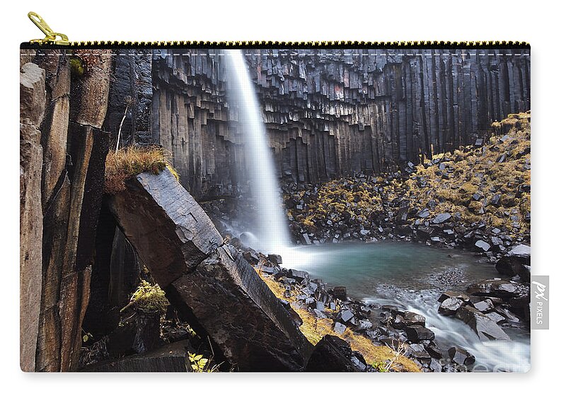 Waterfall Zip Pouch featuring the photograph Flowing through basalt rocks II by Matteo Colombo