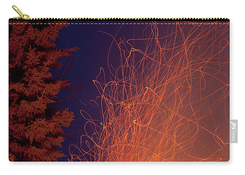 Blast Zip Pouch featuring the photograph Forest fire danger hot spark trails from campfire by Stephan Pietzko