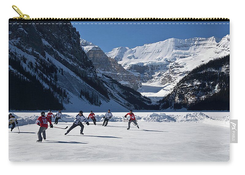 Photography Zip Pouch featuring the photograph Hockey Players Playing On The Frozen by Panoramic Images