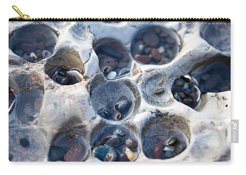 Holey Rock Zip Pouch featuring the photograph Holey Rock - Ocean - Pebbles by Marie Jamieson