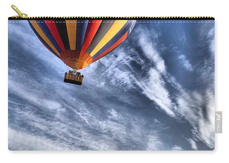 Balloons Zip Pouch featuring the photograph Hot air balloon in a vivid blue sky by Mick Flynn