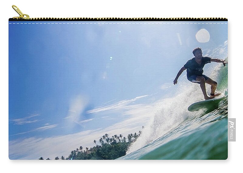 Expertise Zip Pouch featuring the photograph Man Surfs Waves On Sunlit Sea, Palm by Ascent Xmedia