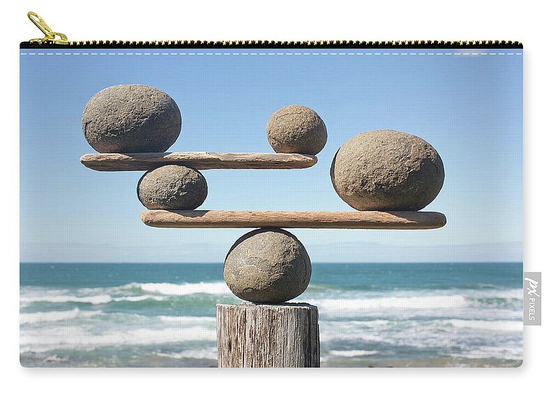Driftwood Zip Pouch featuring the photograph Rocks Balancing On Driftwood, Sea In by Dimitri Otis