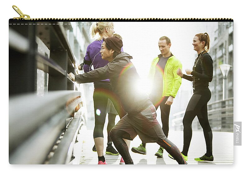 Young Men Zip Pouch featuring the photograph Runners Preparing In Urban Invironment by Henrik Sorensen