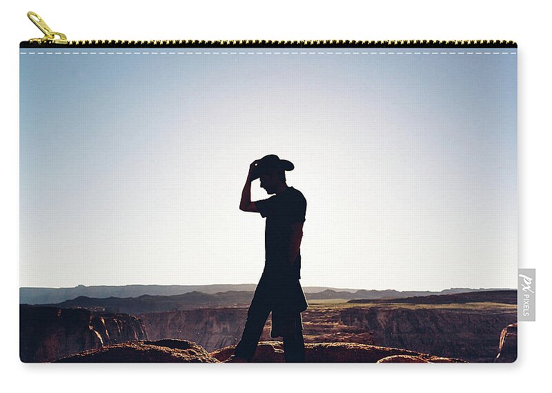 Scenics Zip Pouch featuring the photograph Silhouette Of Hiker With Cowboy Hat by Deimagine