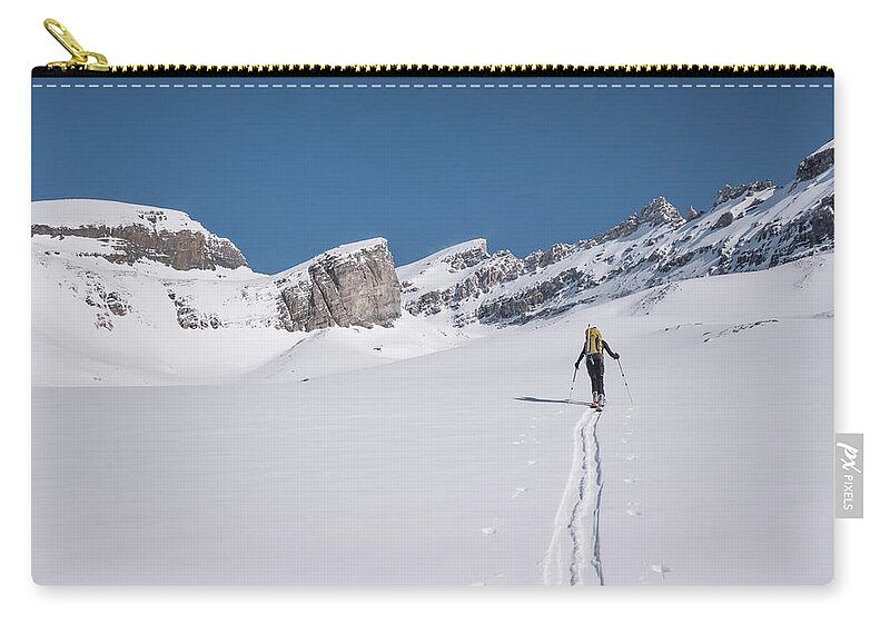 Scenics Zip Pouch featuring the photograph Skier Lays New Track Across Snowslope by Ascent Xmedia