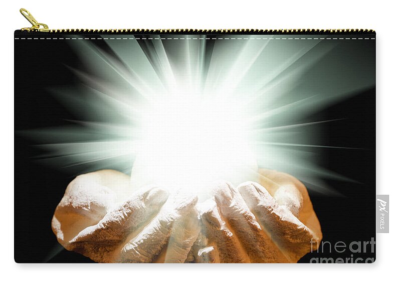 Spiritual Carry-all Pouch featuring the photograph Spiritual light in cupped hands on a black background by Simon Bratt