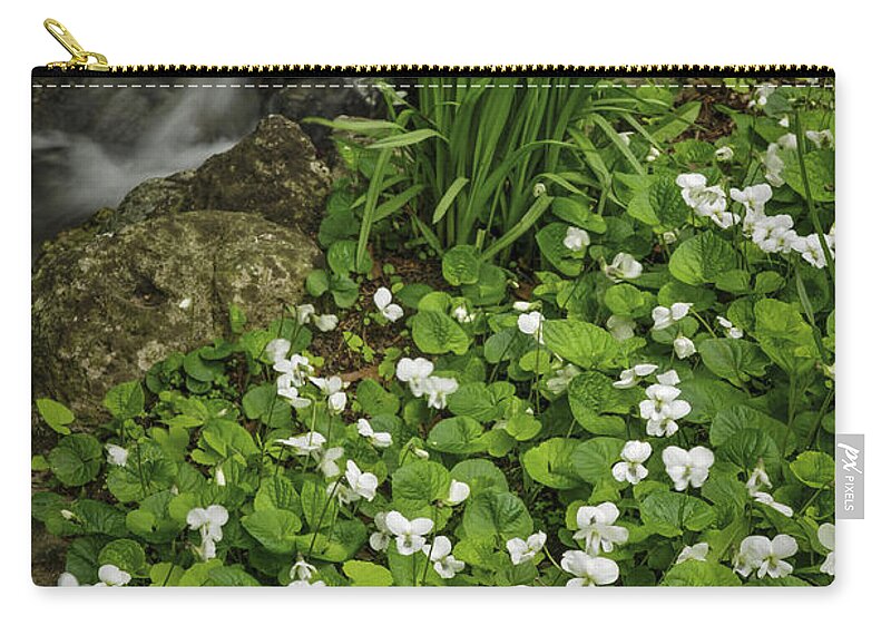 Spring Zip Pouch featuring the photograph Spring flowers near creek by Elena Elisseeva