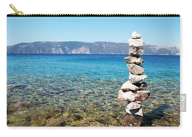 Heap Zip Pouch featuring the photograph Stone Tower On The Beach by Gosiek-b