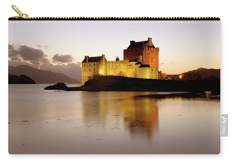 Built Structure Zip Pouch featuring the photograph The Illuminated Castle Of Eilean Donan by David C Tomlinson
